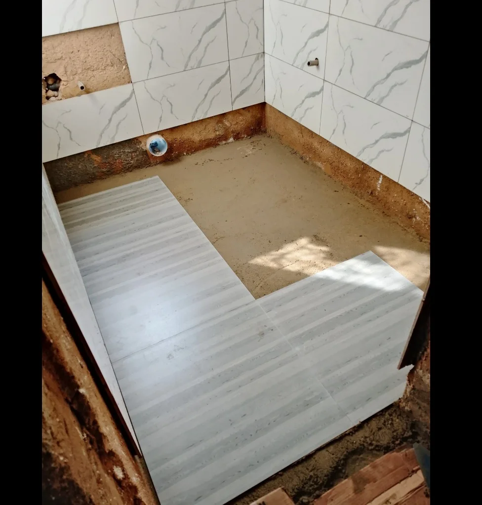 image of fundi applying tiles on a bathroom for a house in kenya